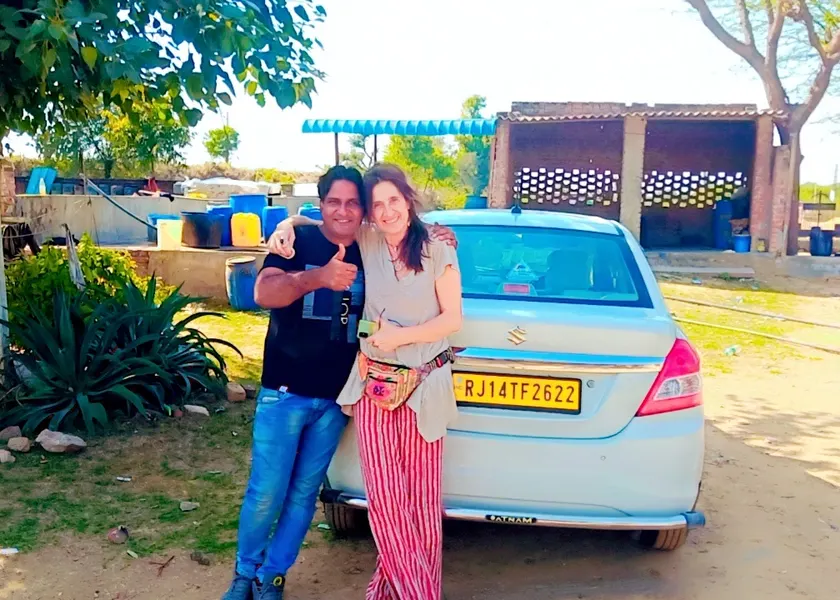 Guests beside a white sedan cab
